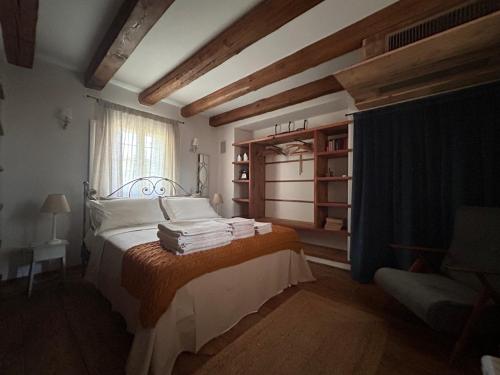a bedroom with a bed with towels on it at Il Glicine - Natural BnB in Castello di Godego