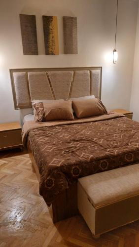 um quarto com uma cama grande e uma grande cabeceira. em Furnished luxury apartment no Cairo