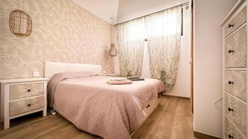 a small bedroom with a bed and a window at Diamond Roof in Los Cristianos
