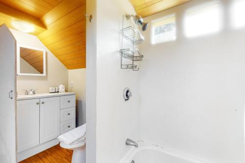 a bathroom with a shower and a sink at Black Cove Cottage in Manchester
