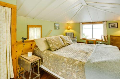 a bedroom with a bed and a chair in a room at Peaceful Fishermans Paradise with Deck and Fire Pit! in Winthrop