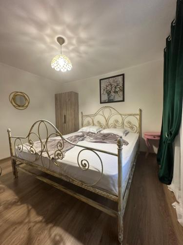 a bedroom with a white bed with a chandelier at La Mosie in Corbu