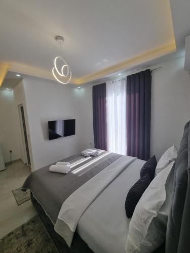 a bedroom with a large bed and a window at Kahari Apartments in Ulcinj