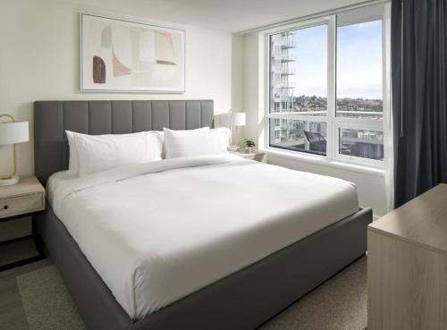 a bedroom with a large white bed and a window at Level Chicago Fulton Market in Chicago