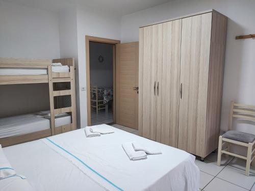 a bedroom with a bed and a cabinet and a bunk bed at SummerhouseVelipoje-Te Kompleksi Fishta-Q1,36 in Velipojë