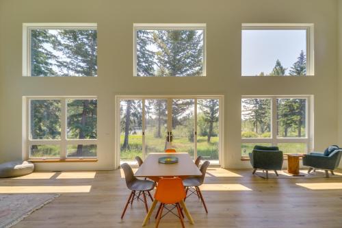 a room with a table and chairs and windows at Columbia Falls Home with Patio Near Glacier NP! in Columbia Falls
