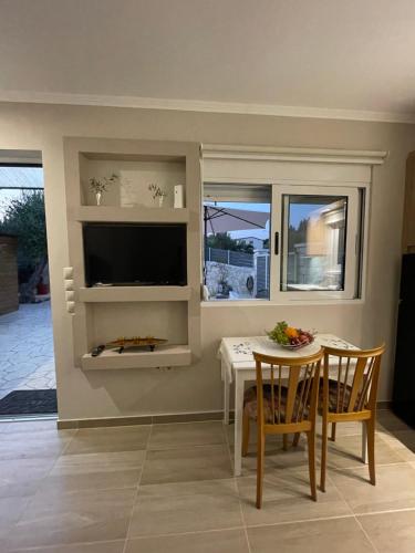 a living room with a table and a tv at Elia House in Chania Town
