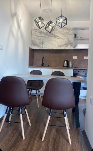a kitchen with a table and four chairs at Skopje Kale Luxury Apartment in Skopje