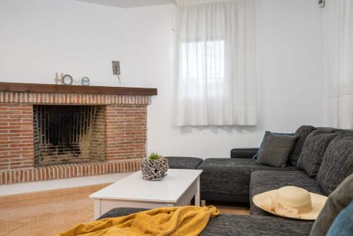 a living room with a couch and a fireplace at Villa Caleta - PlusHolidays in Calpe
