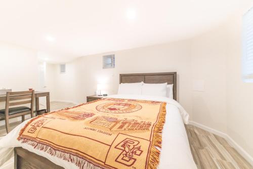 a bedroom with a bed with a blanket on it at The Boston Rental - Multiple Floorplans in Boston
