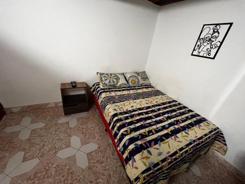 a bedroom with a bed and a wall at Aparta Suite Torre De Prado 503 in Medellín