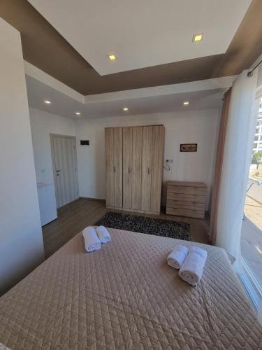 a bedroom with a bed with two towels on it at Kahari Apartments in Ulcinj