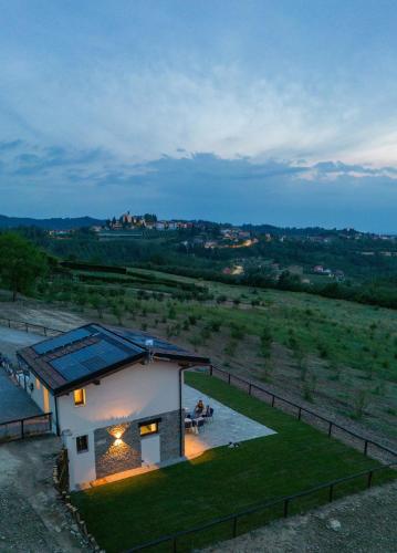 a small house with a solar roof on a field at Il Casot Private House with Pool in Borgomale