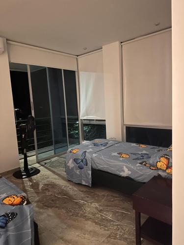 a bedroom with a bed and a large window at Villa campestre Casa Blanca Full House in Agua de Dios
