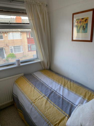 a small bed in a bedroom with a window at Hadfield Avenue in Hoylake