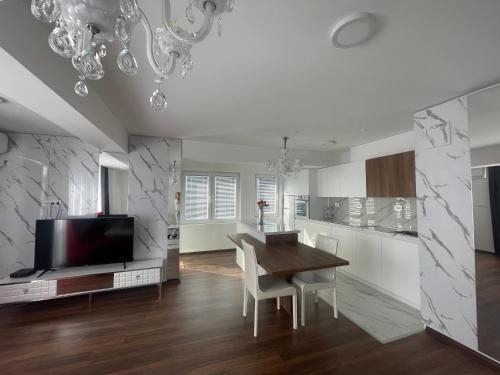 a kitchen and dining room with a table and a tv at Skopje Kale Luxury Apartment in Skopje