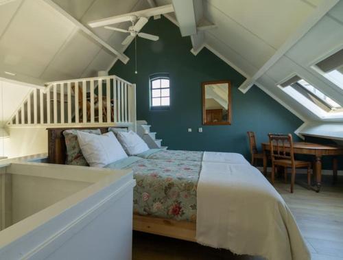 a bedroom with a bed in a room with green walls at Het Betuws Erfje in Maurik