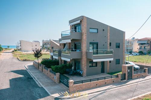 a large building with a balcony on a street at Artline Luxury Suites in Flogita