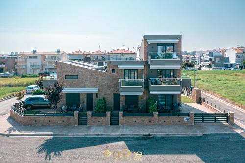 a house with a car parked in front of it at Artline Luxury Suites in Flogita