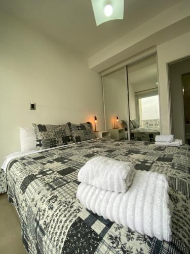 a bedroom with a large bed with a large window at Efimero San Juan, pleno centro in San Juan