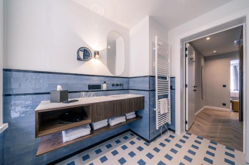 ein Bad mit einem Waschbecken und einem Spiegel in der Unterkunft Hotel Du Parc in Ostende