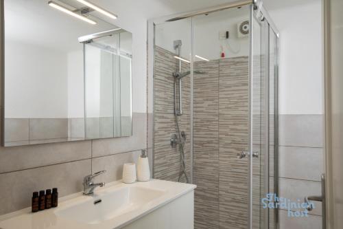 a bathroom with a sink and a glass shower at Porto Rotondo loft sul porto in Porto Rotondo