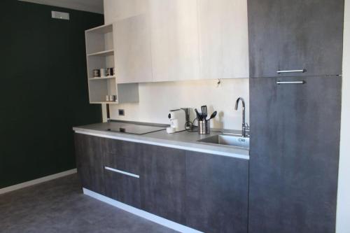 a kitchen with a sink and a stainless steel refrigerator at Dimora 7 fontane in Paola