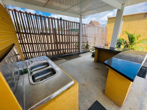 an outdoor kitchen with a sink on a balcony at The Gold Vacation Apartments in Santa Cruz