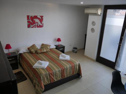 a bedroom with a bed with two towels on it at Habitación Privada en Edificio de Departamentos in Salta