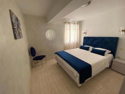 a bedroom with a large bed with a blue headboard at Apartments Villa De Blue in Bol