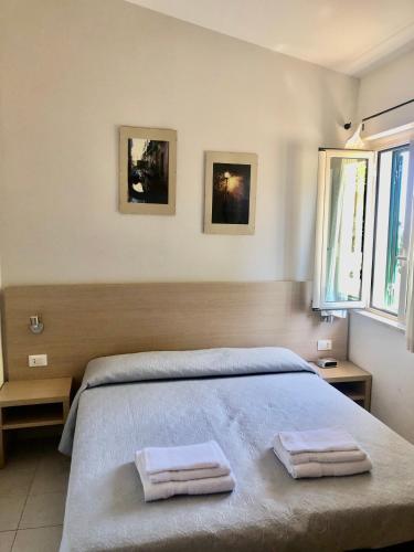 a bedroom with a bed with two towels on it at A View 2 Sea in Parghelia