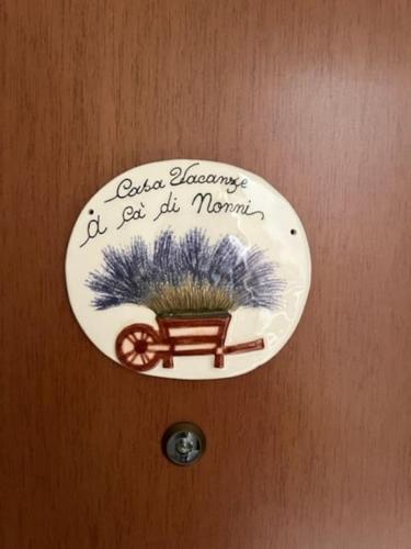 a plate on a door with a sign on it at A cà di nonni in Albenga