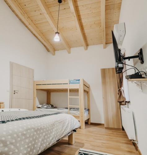 a bedroom with a bed and a bunk bed at Pensiunea Suzanne Băile Figa in Beclean