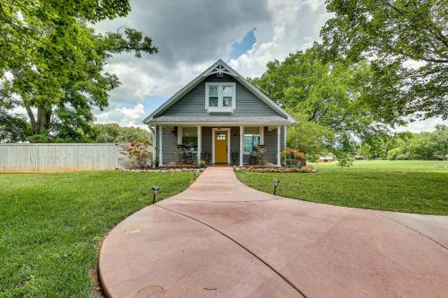 a house with a yellow door on a driveway at Cozy Tennessee Abode with Private Hot Tub and Fire Pit in Winchester