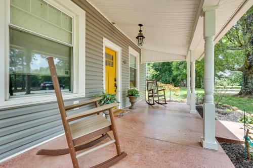 a wooden bench sitting on the front porch of a house at Cozy Tennessee Abode with Private Hot Tub and Fire Pit in Winchester