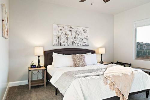 a bedroom with a bed and a painting on the wall at Zion PLAY-cation Home - VIEW of Zion National Park in Hurricane