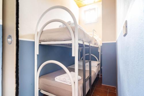 a bunk room with two bunk beds in a room at Frontemare Residence in Fiumefreddo di Sicilia