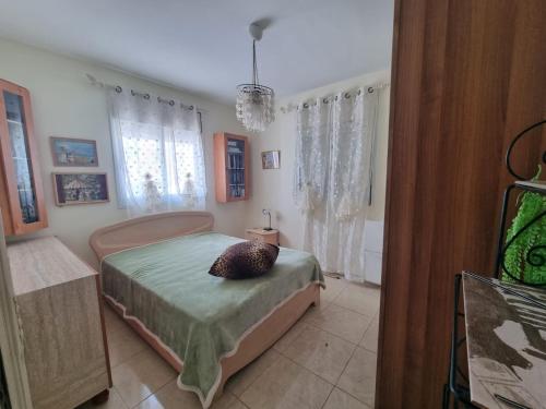 a bedroom with a bed with a pillow on it at Charming Warm and Sun-Filled 1 and 2 Bedroom Apartment in Ashdod