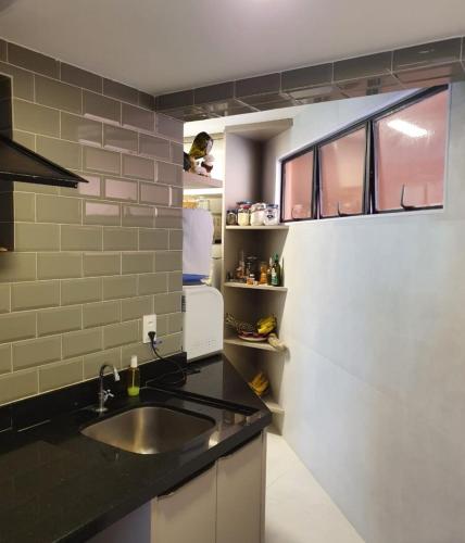 a small kitchen with a sink and a window at Genipabu Summer House Guarajuba in Guarajuba