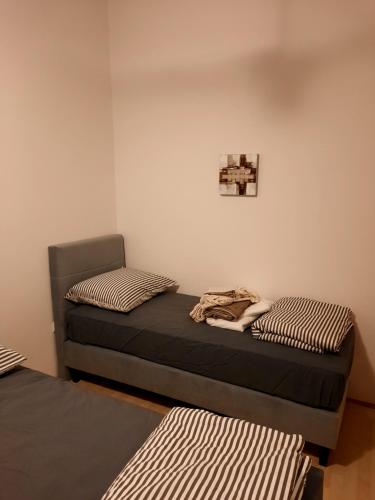 a room with two beds and a picture on the wall at Modern Croatian House in Pula