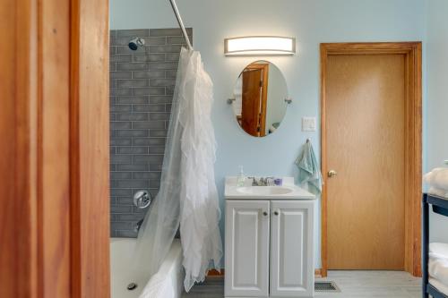 a bathroom with a tub and a sink at Cozy Westmont Home Walk to Metra Station! in Westmont