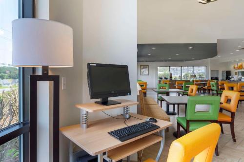 a computer on a desk with a monitor and a keyboard at Comfort Suites Kodak Sevierville in Kodak