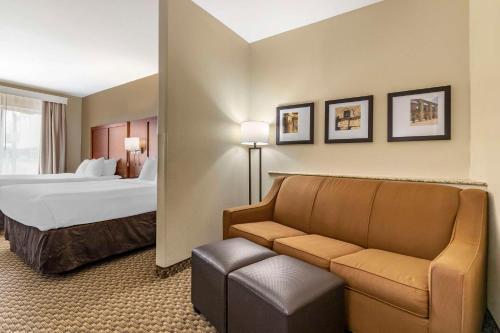 a hotel room with a bed and a couch at Comfort Suites Medical Center Near Six Flags in San Antonio