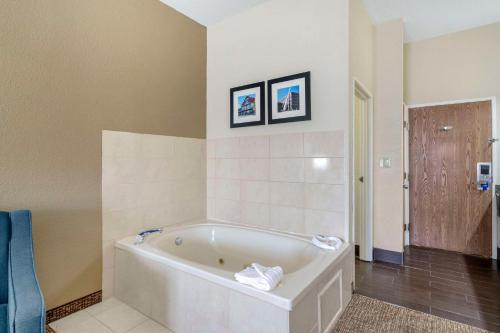 a bathroom with a white tub in a room at Comfort Inn & Suites in La Grange