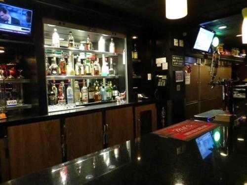 un bar con un montón de botellas de alcohol en Filmores Hotel, en Toronto