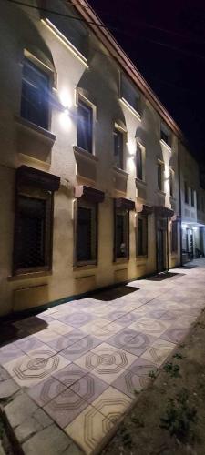 a building with a mosaic on the ground in front of it at Atonika Apartments Bitola in Bitola