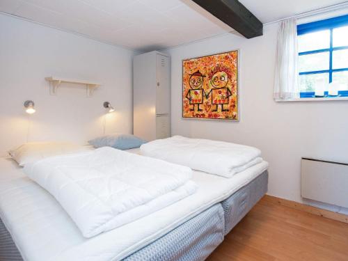 ØrstedにあるHoliday home Ørsted Vの白いベッド2台が備わるベッドルーム1室、壁に絵画が飾られています。