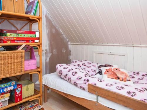 a cat laying on a bed in a room at 6 person holiday home in Ørsted-By Traum in Ørsted