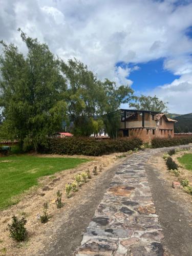 a stone path leading up to a building at Casona Ananda in Firavitoba