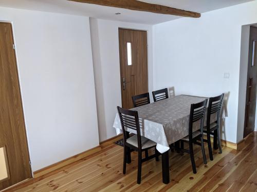 a dining room with a table and chairs at Pałaszówka in Wolimierz